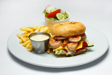 shrimp burger with caviar, vegetable salad and french fries, shrimp sauce