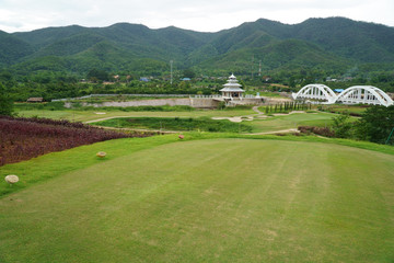 Fototapeta na wymiar view at the beautiful golf course with white bridge railway background