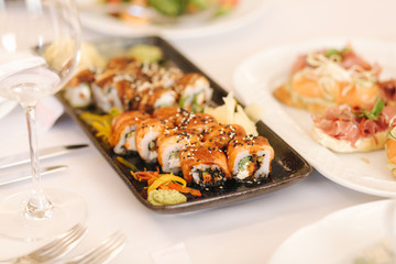 Philadelphia roll sushi with eel fish on the table in the restaurant. Asian food. Banquet concapt