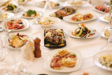 Fototapeta na wymiar Table with mixed food. Banquet in restaurant, table setting. Differend meals for the guests. Fresh food
