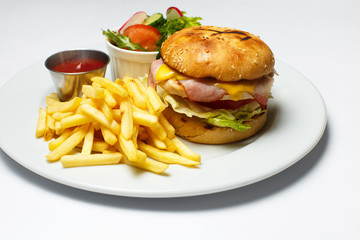 bacon burger with chicken cutlet, french fries, salad