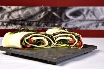 basil pesto mozzarella roulade served on stone