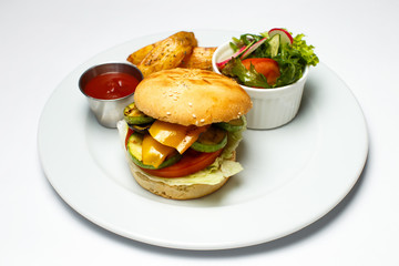 veggie burger with baked potatoes and salad