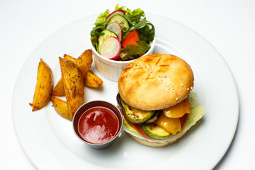 veggie burger with baked potatoes and salad