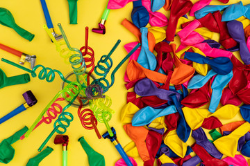Colored spiral straws and party accessories, flat lay