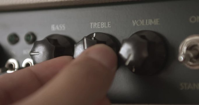 Guitar Player Adjusting Bass Treble And Volume Knobs On Tube Amp. Music Related 4K Concept
