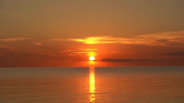 Colorful sunset over calm sea water near tropical beach. Summer vacation concept. Island Koh Phangan, Thailand