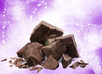 Close-up broken chocolate bar isolated on white background