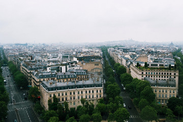 Fototapeta na wymiar Aerial view of Paris with Sacre Coeur from the Arc de Triomphe in a cloudy day.