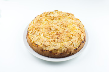 Baked cake with almonds on white background