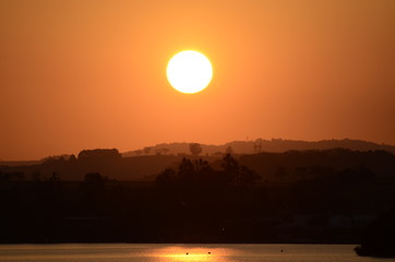  Late afternoon at the dam with the sun and its reflection in the water