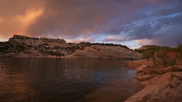 Panning view of vibrant sunset over desert reservoir at Red Fleet near Vernal Utah.