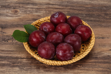 Plum heap in the wooden basket