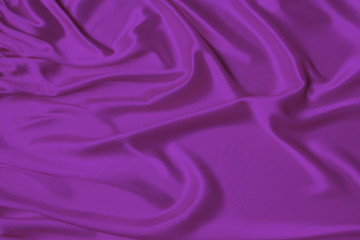 lilac beautiful satin draped with soft folds fabric, silk cloth background, close-up, copy space