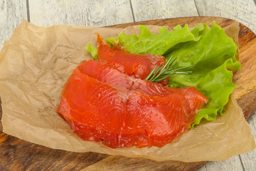 Sliced salmon fillet served rosemary