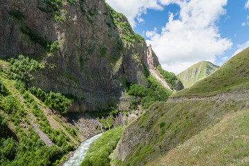 Fototapeta na wymiar Truso Valley and Gorge area landscape on trekking / hiking route, in Kazbegi, Georgia. Truso valley is a scenic trekking route close to the border of North Ossetia.