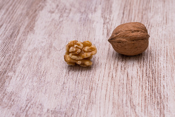 Whole walnuts on cream colored wood, healthy food