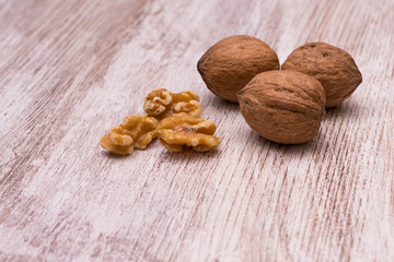Whole walnuts on cream colored wood, healthy food