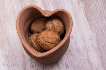 Whole walnuts on cream colored wood, healthy food