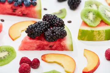 delicious dessert with watermelon and berries on white background