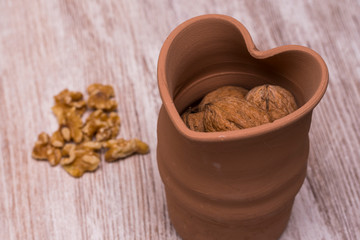 Whole walnuts on cream colored wood, healthy food