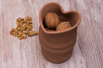 Whole walnuts on cream colored wood, healthy food