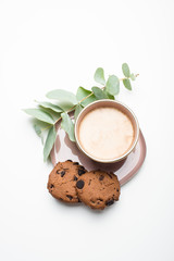 Beautiful enameled cup of coffee with cookies