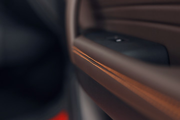 Part of stitched leather black leather car interior. Modern luxury car black perforated leather interior. Car leather interior details