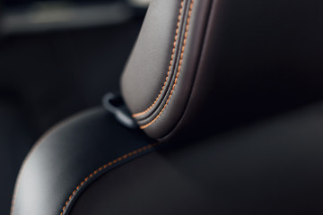 Part of stitched leather black leather car interior. Modern luxury car black perforated leather...