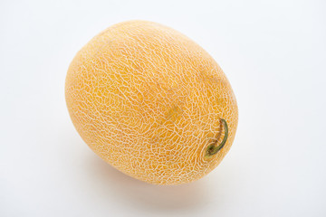 whole ripe yellow sweet melon on white background