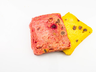 Whole wheat bread mixed with pumpkin and beetroot, isolated on a white background.