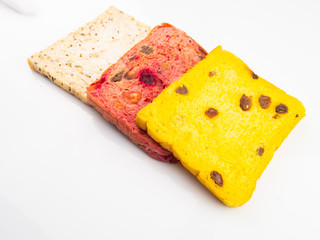 Whole wheat bread mixed with pumpkin and beetroot and black sesame seeds, isolated on a white background.