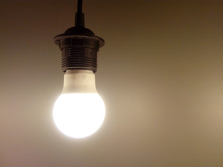 LED energy-saving eco-friendly lamp on a neutral background. Blank for text overlay. Energy saving concept.