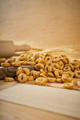 crunchy breakfast on a wooden table with ears of rye and rolling pin