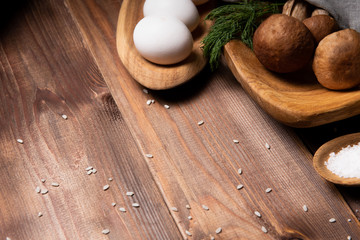 wooden tray with porcini mushrooms on a wooden table. Ingredients before cooking. Copy space