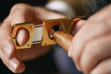 Man Cutting Cigar