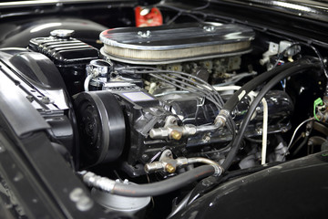 Fototapeta na wymiar Vintage V8 engine with chrome accessories in a classic car.