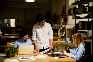 Coworkers working late in office