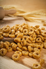 crunchy breakfast on a wooden table with ears of rye and rolling pin