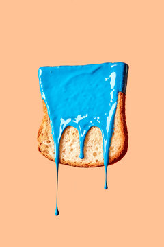 Dry freshly toast in a blue paint on a pasrel background with copy space.