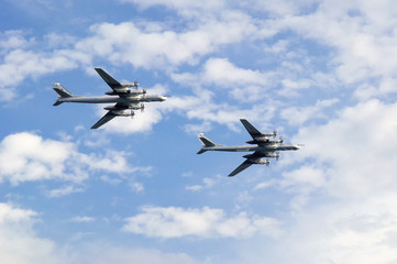 Two heavy turboprop bombers in the sky.