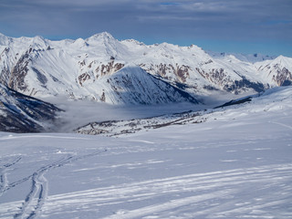 Fototapeta na wymiar France, Meribel valley: Panoramic landscape view down valley with ski slope piste in winter alpine mountain resort