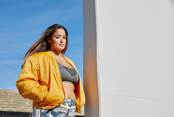 Confident body positive woman outdoors in an urban location
