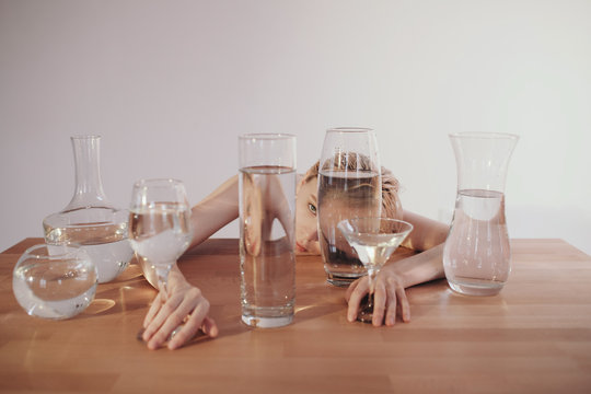 Sensual woman with glassware full of water