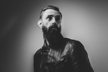 Black and white portrait of man with hope in his eyes on the light background.