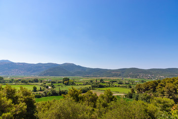 Fototapeta na wymiar Beautiful natural landscape with green fields and mountains. Greece