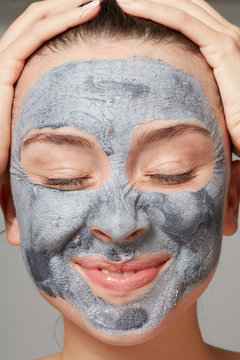 Fun woman with clay mask