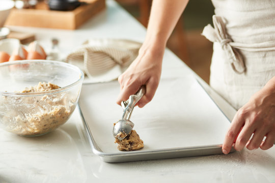Chef making portions of raw dough.