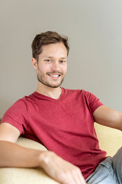 Portrait of a smiling man sitting on a couch