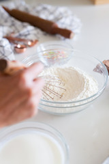 woman whisking flour in kitchen